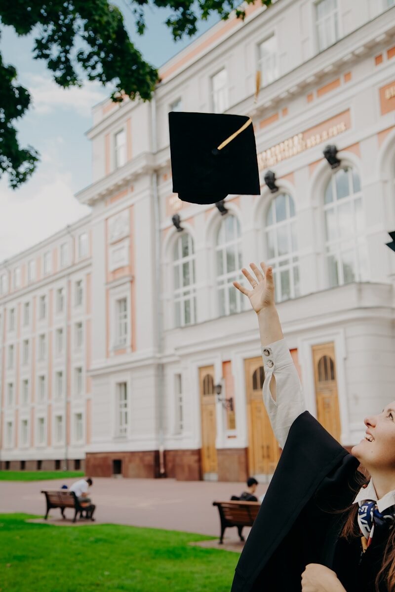 woman in black academic dress and red scarf